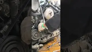 Car Engine Belt Installation: Fitting Serpentine Belt on Pulley System