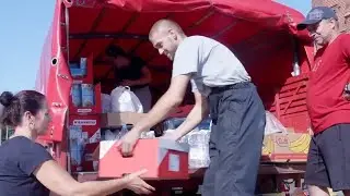 Firefighters distribute food and water supplies to residents in flooded Czech town