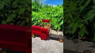 The tractor pulling the trailer is made entirely from popsicle sticks