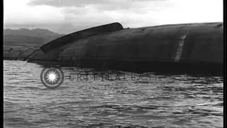A wrecked plane and ships and smoke from explosions after the Japanese air attack...HD Stock Footage