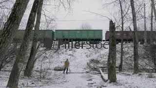 Timelapse of man shooting video of cargo train passing by