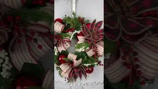 Rustic Christmas wreath with red plaid poinsettias. #christmaswreath #christmasdecor #christmas