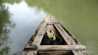 old school vintage wooden boat ride in the middle of deep scary beautiful forests of vietnam