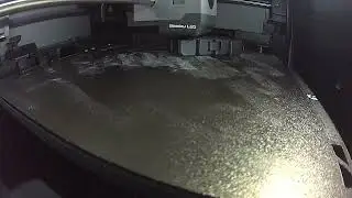 3-d printing a black fidget cube toy.