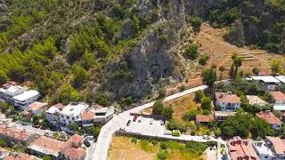 Fethiye, Turkey. Panoramic aerial view of ancient Lycian rock cut tombs in the dramatic cliffside...