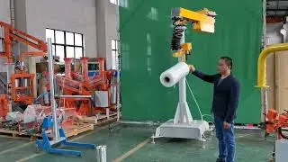 Pneumatic film roll handling robot with clamping mechanisms at both ends for lifting and rotating