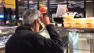 Man Sips Soup From Ladle at Chicago Supermarket Buffet