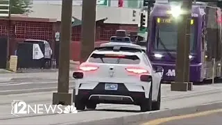Waymo car seen driving on light rail tracks in Phoenix