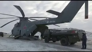 Russian Mi-26 carries a tank truck and a Bulldozer