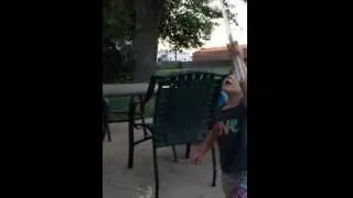 Whacking bubbles while daddy sits.