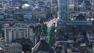 Aerial views capture meir street in Antwerp, Belgium, filled with people enjoying a sunny day. The