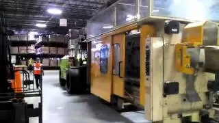 Specialty Moving & Rigging Inc. Moving out a old Husky Injection machine.