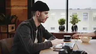 Man at the coffee shop working on his laptop