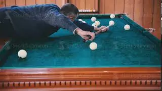 Man rolls the ball into the hole