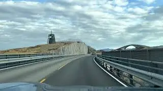 Driving over the Storseisundet Bridge on the Atlantic Road in Norway in a Porsche Taycan