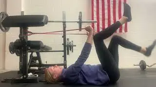 Dead bug heel taps with band pull down