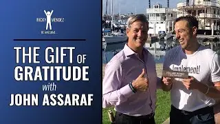 John Assaraf giving a Gratitude coin to Ricky Mendez