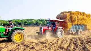 John deere and massey ferguson 241di tractors pulling heavy load of hay