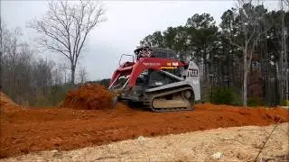Takeuchi TL12 Pushing Down Dirt