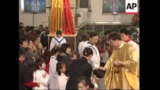 Faithful gather for Christmas mass; Christmas tree