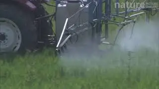 Close-up of a tractor spraying pesticide or fertiliser on a field, France