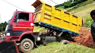 Tow truck pulling a dump truck.