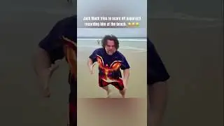 Jack Black scares off paparazzi recording him at Gold Coast beach.