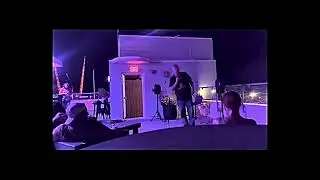 Comic punches host at open mic