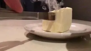 Hot knife cutting into butter
