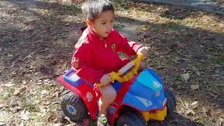 Arri playing with his Power Wheels Nickelodeon PAW Patrol Lil' Quad toy car outside