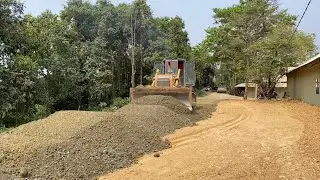 Mighty SHANTUI SD13 Bulldozer pushing, splitting gravel with dump trucks for new road foundation