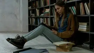 Girl Working on The Floor of a Library | Free Library Stock Video | No Copyright