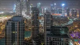 Aerial panoramic view of a big futuristic city all night timelapse. Business bay and Downtown