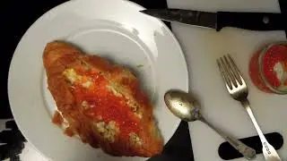 Caviar Breakfast in a French Croissant. Scrambled eggs and salmon eggs wrapped in butter Croissant