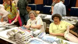 Netroots Nation 2017 volunteers sing as they make swag bags