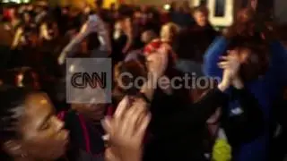 MANDELA: DANCING AND SINGING OUTSIDE HOME (NIGHT)