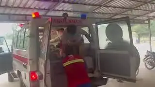 EMT's unload an innocent Cambodian Chouk Chey villager at the local hospital after being shot byThai