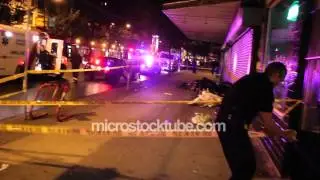 Officer unrolling police tape towards camera