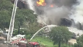 Houston firefighters are battling a three-alarm fire at a warehouse in southwest Houston