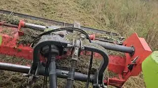 Steep bank topping grass with Claas tractor 