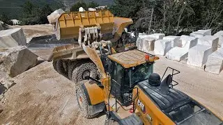 CAT 980 wheel loader and CAT 770 dump truck in marble quarry.