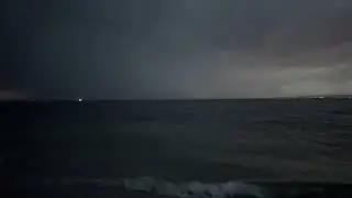 Evening Storm Clouds Lightning over the Atlantic Ocean seen from Breezy Point Queens NYC Beach USA