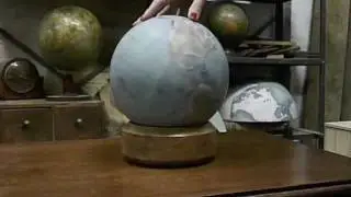 Mini desk globe being spun by hand