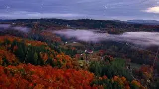 expansive sunsethued valley scene, balloon adventure over foggy mountain ridges with vibrant foliage