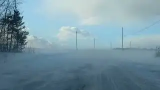 Wicked wind blows Snow over Road.Woodstock,NB.