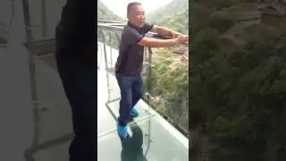 scared guy on glass bridge