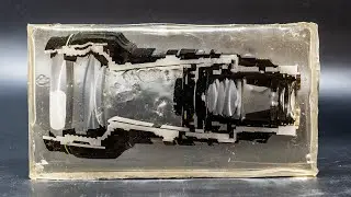 1996 Camera Lens Cast In Epoxy Resin And Cut In Half