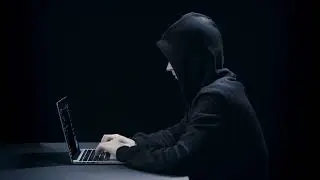 VideoVault Stock Video: Hacker cracking a firewall on his laptop