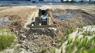Bulldozer SHANTUI DH17 C3 Push soil leveling land with dump trucks pouring soils 