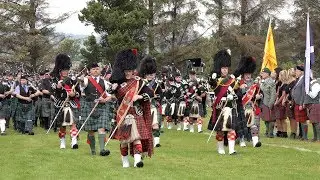 Massed Pipe Bands Salute the Chieftain opening the 2019 Dufftown Highland Games in Scotland